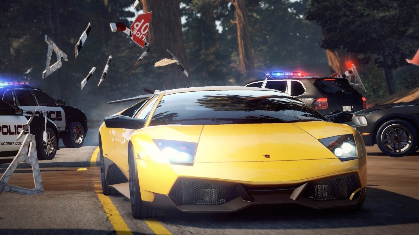 NFS Hot Pursuit Remastered screenshot showing Lamborghini crashing through police barrier