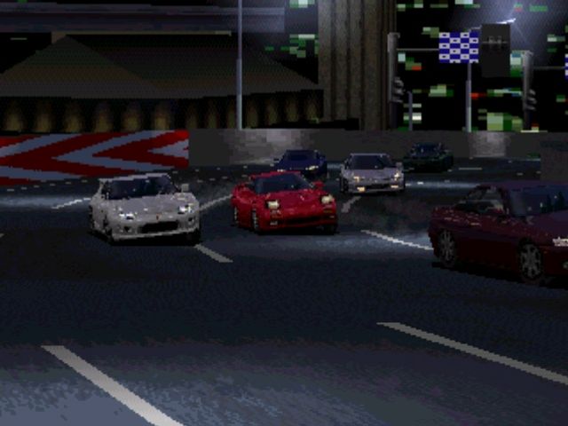 Gran Turismo night race with headlights and track lighting visible ahead.