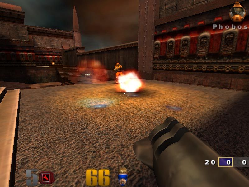 Quake III Arena firefight in a metallic arena with weapons and damage effects on screen.